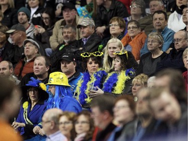Team Alberta fans dressed up as they sat amongst other curling fans to watch the afternoon draw of the Tim Hortons Brier at the Scotiabank Saddledome on March 4, 2015.