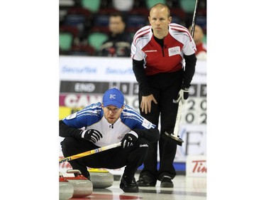 B.C. skip Jim Cotter kept an eye on a shot by his team as Canada's Pat Simmons watched over his shoulder during the Wednesday morning draw of the Tim Horton's Brier at the Scotiabank Saddledome on March 4, 2015. Canada scored 2 in the final end to defeat B.C. 8-7.