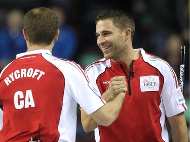 Team Canada's John Morris, right, and Carter Rycroft celebrated after their team defeated B.C. 8-7 in the final end during the Wednesday morning draw of the Tim Hortons Brier.