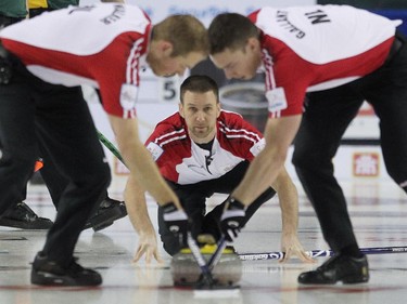 Newfoundland Labrador skip Brad Gushue kept an eye on his shot as sweepers Geoff Walker, left, and Brett Gallant carried it down the ice during the morning draw of the Tim Hortons Brier at the Scotiabank Saddledome in Calgary on March 5, 2015. Newfoundland Labrador won 6-5 handing Northern Ontario its first loss of the Brier.