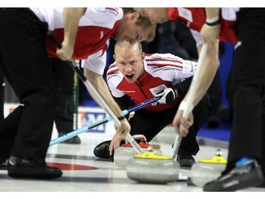 Team Canada third Pat Simmons, centre, yelled to sweepers second Carter Rycroft, left, and lead Nolan Thiessen as they swept a shot by skip John Morris during their game against PEI at the Tim Hortons Brier at the Scotiabank Saddledome on March 1, 2015.