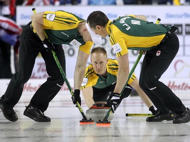 Northern Ontario skip Brad Jacobs kept an eye on his shot as his front end Ryan Harnden, left, and E.J. Harnden swept it down the ice during the morning draw of the Tim Hortons Brier at the Scotiabank Saddledome in Calgary on March 5, 2015. Newfoundland Labrador won 6-5 handing Northern Ontario its first loss of the Brier.