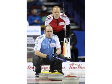 Quebec skip Jean-Michel Menard, foreground, kept an eye on his teams shot as Team Canada skip Pat Simmons tracked it from behind during the morning draw of the Tim Hortons Brier at the Scotiabank Saddledome in Calgary on March 5, 2015. Both teams had a record of 6-3 going into the morning game and Team Canada claimed the win with a score of 7-5 over Quebec.