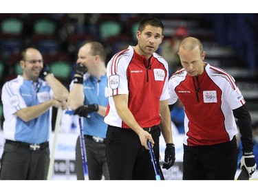 Team Canada third John Morris, foreground left, and skip Pat Simmons, right, discussed what shot to play against Quebec during the morning draw of the Tim Hortons Brier at the Scotiabank Saddledome in Calgary on March 5, 2015. Both teams had a record of 6-3 going into the morning game and Team Canada claimed the win with a score of 7-5 over Quebec.