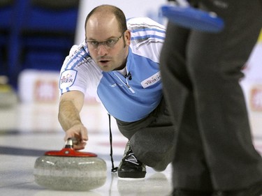 Quebec skip Jean-Michel Menard slid with the rock during the morning draw against Team Canada during the Tim Hortons Brier at the Scotiabank Saddledome in Calgary on March 5, 2015. Both teams had a record of 6-3 going into the morning game and Team Canada claimed the win with a score of 7-5 over Quebec.