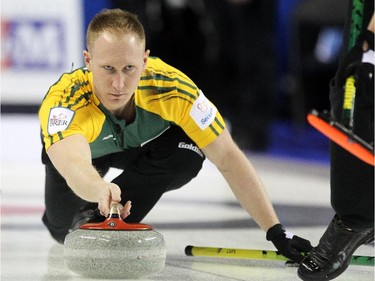 Northern Ontario skip Brad Jacobs delivers his rock into the hands of his sweepers during his Sunday afternoon match against BC at the Tim Hortons Brier at the Scotiabank Saddledome on March 1, 2015.