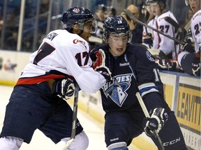 Lethbridge Hurricanes captain Jamal Watson, left, hits Saskatoon's Ryan Graham during a game earlier this season. Watson is committed to the Canes, aiming to return them to playoff respectability next season.