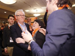 NDP Premier Greg Selinger celebrates his win with son Eric (left to right), wife Claudette and son Pascal at the Manitoba NDP leadership convention in Winnipeg, Sunday, March 8, 2015.