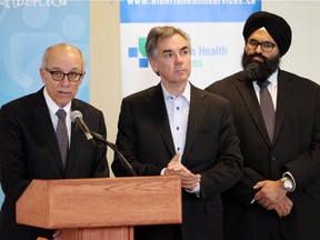 Health minister Stephen Mandel; left, Premier Jim Prentice; and Minister of Infrastructure, Manmett S. Bhullar were on hand to  announce health facility expansions. and a new cancer centre in Calgary that will be built in two places.