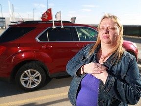 Gloria Roberts had her purse stolen from her SUV along with photos and mementos of her late husband and mom and she is appealing for the thief to return the  items. Roberts was photographed with her vehicle on Friday, March 27, 2015.