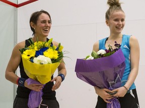 Emily Whitlock, right, of England, receives flowers with Rachael Grinham, of Australia, after their final game match up during the Calgary Women's Squash Week Pro-Am Tournament at the Calgary Winter Club, on Sunday. Whitlock won the championship title in five sets after coming back from 2-1 down.