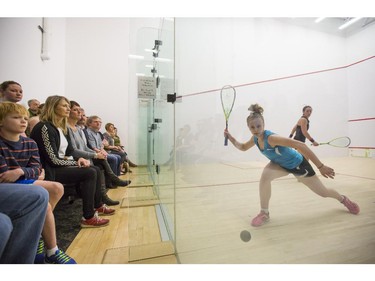 Emily Whitlock, front right, of England, swings for the ball during a match up against Rachael Grinham, of Australia, during the Calgary Women's Squash Week Pro-Am Tournament final match at the Calgary Winter Club, on March 15, 2015. Whitlock won the championship title after winning the fifth match in the best of five.