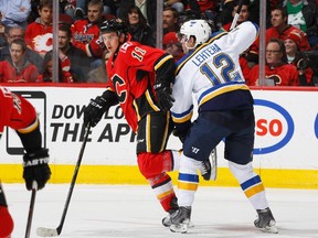 Mikael Backlund of the Calgary Flames battles for the puck against Jori Lehtera of the St Louis Blues on Tuesday. Backlund and his mates earned a day off on Wednesday before resuming the chase for a playoff spot.