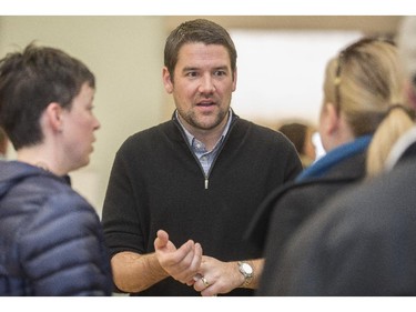 Evan Woolley, centre, ward 8 councillor, discusses secondary suites while at an information open house at Killarney community hall in Calgary, on March 1, 2015.