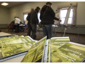 Attendees get information about secondary suites at an open house at Killarney community hall in Calgary, on March 1, 2015.