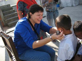 Dr. Esther Tailfeathers has been treating patients suspected of taking fentanyl on the Blood Reserve. In this file photo, Dr. Tailfeathers treats patients at an orphanage in Kathmandu.