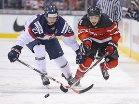 Calgary's Brayden Point, right, battles Slovakia's Michael Kabac during a semi-final game in the 2015 IIHF World Junior Hockey Championship at the Air Canada Centre in Toronto. Point has built off the experience to lead the Moose Jaw Warriors down the stretch of the Western Hockey League season.