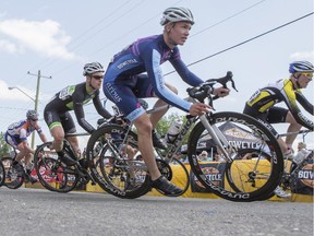 Bikers round a corner at the Tour de Bowness bike race in Calgary, on August 4, 2014.