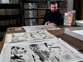 Michael Hoskin, Special Collections curator at the University of Calgary, with Nelvana of the Northern Lights comic book and other collectible original comics.