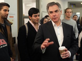 Premier Jim Prentice talks with students after meeting with the University of Calgary's board of governors in February to discuss the upcoming provincial budget. Reader says tuition hikes will hurt the poor.