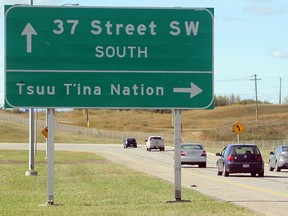 Traffic drives past a direction sign on Anderson Road S.W. sits just outside the entrance to the Tsuu T'ina Nation.