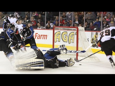 Calgary Hitmen left winger Radel Fazleev, right, scores on Kootenay Ice goalie Wyatt Hoflin at the Scotiabank Saddledome in Calgary on Friday, April 3, 2015. The Calgary Hitmen tied the Kootenay Ice, 1-1, at the first period in Game 4 of the Western Hockey League first-round playoff series.