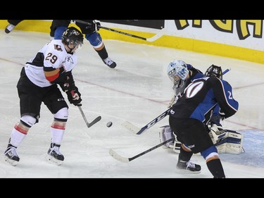Calgary Hitman Radel Fazleev, left, fails to connect a shot on net at the Scotiabank Saddledome in Calgary on Friday, April 3, 2015. The Calgary Hitmen lost to the Kootenay Ice, 5-4, in Game 4 of the Western Hockey League first-round playoff series.