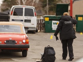 Calgary Police investigate a suspicious death in front of Chetlen Auto along Macleod Trail in Calgary on Saturday, April 18, 2015.