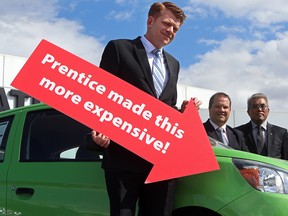 Wildrose leader  Brian Jean, targets the costs of Prentice tax hikes, during a Calgary news conference on April 21.