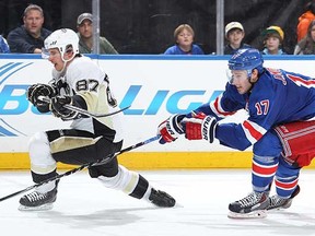 NEW YORK, NY - NOVEMBER 11:  Sidney Crosby #87 of the Pittsburgh Penguins skates against John Moore #17 of the New York Rangers at Madison Square Garden on November 11, 2014 in New York City. The New York Rangers won 5-0. (Photo by Jared Silber/NHLI via Getty Images)