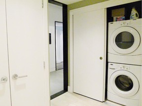 Laundry is tucked into a closet space in this condominium.