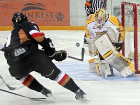 Pavel Karnaukhov #9 of the Calgary Hitmen fires a shot at netminder Jordan Papirny #33 of the Brandon Wheat Kings during the first period of Game 1 of their WHL Eastern Conference series at Westman Place in Brandon on Friday evening. The HItmen lost 9-4.