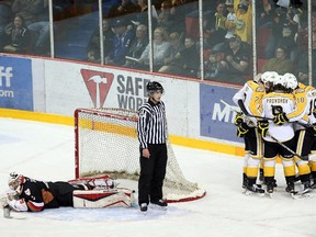 The Brandon Wheat Kings celebrate after scoring a power play goal on Calgary Hitmen netminder Brendan Burke during Game 2 on Saturday night.