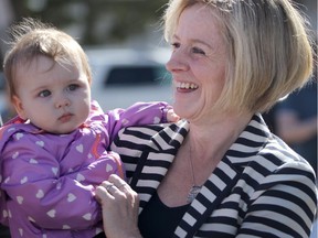 New Democrat Leader Rachel Notley holds 8 month old Vesper Mackenzie, daughter of Calgary-East ND candidate Robyn Luff, while making an education announcement in Calgary on Thursday.