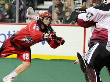 The Calgary Roughnecks' Sean Pollack releases a shot against Colorado Mammoth goaltender Alex Buque during National Lacrosse League action at the Scotiabank Saddledome on Saturday April 4, 2015.