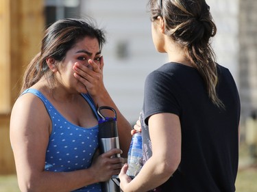 A home owner shows the emotion of seeing her home damaged by flames in a large fire on Hidden Valley Drive on April 20.