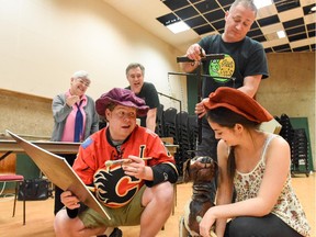 A group of Calgary artists, including playwright Ann Gatha, composer Arthur Bachman, actor Jonathan Love (in Flames jersey) and puppeteer Dean Bareham of the Green Fools in Ottawa, rehearsing their production of A Paintbrush for Piccolo with Sadie Laflamme-Snow, who plays Piccolo. The symphony for young audiences is being presented May 2, 2015 at the National Arts Centre.