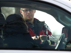 Calgary traffic unit officer Dave Den Tandt talks to a motorist in Willow Park after running photo radar to catch speeders.