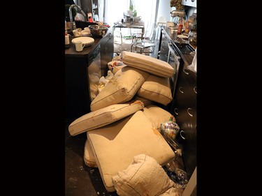 Damaged couch cushions were piled up in the kitchen of this Sage Hill home.