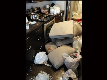 Damaged couch cushions were piled up in the kitchen of this Sage Hill home.