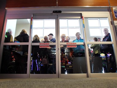Customers lined up waiting for the doors to officially open during the opening of the new Century Downs Casino and Racetrack in Balzac on April 1, 2015.