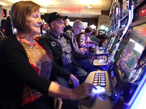 Century Downs customers Gladys and Jim Jones played the penny slots just after they were turned on during the official opening of the new Century Downs Casino and Racetrack in Balzac on April 1, 2015.