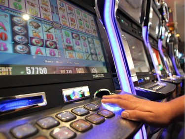 Century Downs customers played the penny slots just after they were turned on during the official opening of the new Century Downs Casino and Racetrack in Balzac on April 1, 2015.