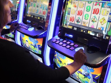 Century Downs customers played the penny slots just after they were turned on during the official opening of the new Century Downs Casino and Racetrack in Balzac on April 1, 2015.