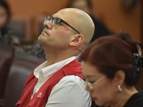 Neil Bantleman and his interpreter listen to court judges reading a verdict in his sexual abuse case Thursday.
 on April 2, 2015.