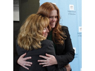 Calgary Board of Education trustee-elect for Wards 11 and 13 Julie Hrdlicka, right, gets a hug from board chair Joy Bowen-Eyre during her swearing in ceremony at the CBE offices Monday April 20, 2015.