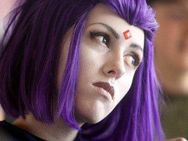 Amy Gallant , made up  as Raven from Teen Titans, waits in line for the opening of the Calgary Comic and Entertainment Expo Thursday April 16, 2015 at the BMO Centre.