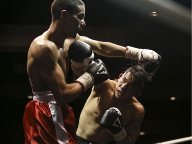 Lightweights Roxie Lam, right, swings for Wayne Smith's face at the Teofista boxing series 15 in Calgary, on April 3, 2015. Lam won the bout.