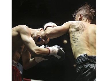 Lightweights Roxie Lam, right, makes contact with Wayne Smith's face at the Teofista boxing series 15 in Calgary, on April 3, 2015. Lam won the bout.