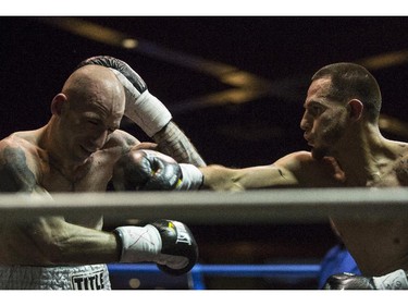 Lightweights Dave Aucoin of Brantford, Ont., left, and Mario Perez of Toronto, Ont., right, duke it out at the Teofista boxing series 15 in Calgary, on April 3, 2015. Perez won the bout.